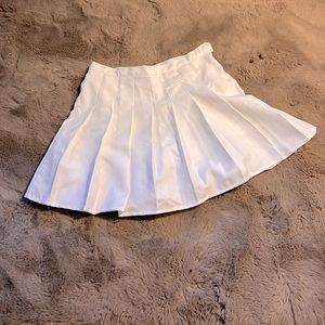 White tennis skirt, new. Side zip. Undershorts attached. No stretch. True2 size